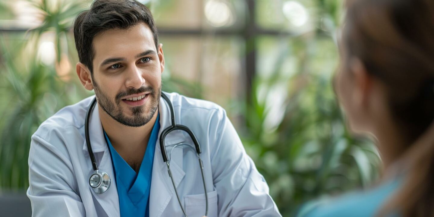 male doctor smiling with patient in office